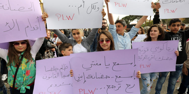 A Lebanese woman holds a placard during a protest in front of Lebanon's Supreme Shiite Council to ask clerics to increase the age at which custody of children for divorced Shiite Muslim couples can be awarded to the mother, in the capital Beirut on March 18, 2017. The writing in Arabic reads: ''Rita, you speak on behalf of all of us! The custody of your son is above all'' - Current law dictates that when toddlers pass a certain age, custody is automatically awarded to the father. The protest was organized by Lebanese NGO "Protecting Lebanese Women," in particular as a reaction to the case of Rita Choukeir, who only has three hours of visiting rights with her son. (Photo by ANWAR AMRO / AFP)