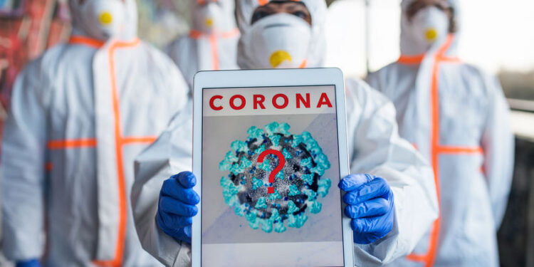 People with protective suits and mask respirators outdoors, coronavirus concept.
